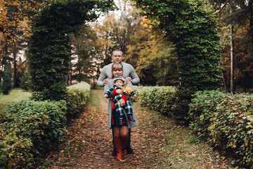 Beautiful and happy family with little child in park.