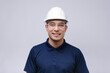 © Руслан Галиуллин - closeup portrait of smiling man architect, builder in blue T-shirt, white helmet and glasses on grey background