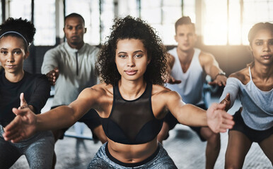 Poster - Great things happen when you clear your mind of cant. Shot of a group of young people doing squats together during their workout in a gym.
