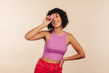 Wall Mural - Smiling woman holding a menstrual cup in her hand