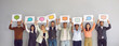 © Studio Romantic - Diverse multiracial multiethnic people show various paper sheets and cards with pictures of different colorful mockup messenger and social media chat icons and message bubbles. Communication concept