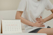 Menstruation, period cycle day of monthly, hurt asian young woman, female hand in stomachache, suffer from PMS premenstrual, belly or abdomen pain on bed at home. Health problem Inflammation in body