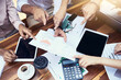 © Ruan Jordaan/peopleimages.com - Taking a closer look at what the data has to say. Closeup shot of a group of unrecognizable businesspeople going through paperwork outdoors.