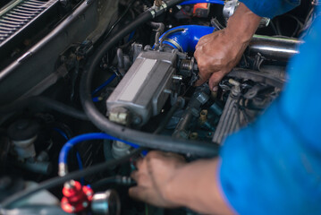 Wall Mural - Auto mechanic working in garage. Repair service.