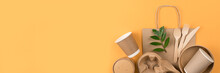 Banner With Eco-friendly Tableware - Kraft Paper Food Utensils, Paper Containers And Cups, Drinking Straws And Wooden Cutlery On Orange Background With Copy Space. Sustainable Food Paper Packaging
