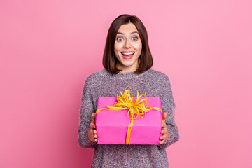 Sticker - Photo of charming impressed lady dressed sweater earphones getting present box isolated pink color background