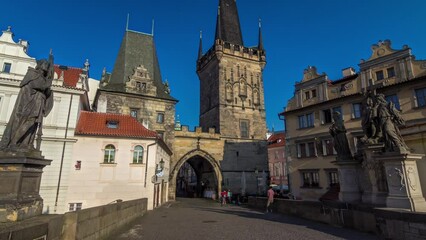 Wall Mural - A view along Charles Bridge in Prague towards the Lesser Quarter in the morning timelapse hyperlapse.