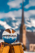 Crystal ball alpine winter landscape shot with a church at Maria Alm, Salzburg, Austria
