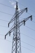 An electricity supply pylon and cables against a blue sky background