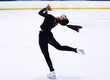 © Siphosethu F/peopleimages.com - To see her skate is to believe in magic. Shot of a young woman figure skating at a sports arena.