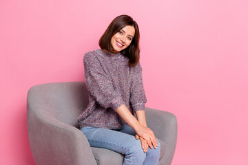 Poster - Portrait of attractive cheerful girl sitting in armchair resting free time isolated over pink pastel color background