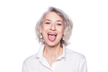 Shot Of A Beautiful Mature Woman Having Fun And Teasing Sticking Out Her Tongue Isolated On White Background