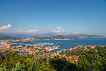 Wall Mural - Sunny panoramic view of the city and the bay, port for ships from the distance. Tourism and transport. Rest and travel. Summe day.