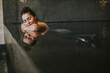 © BGStock72 - Young woman relaxing on the poolside of indoor swimming pool