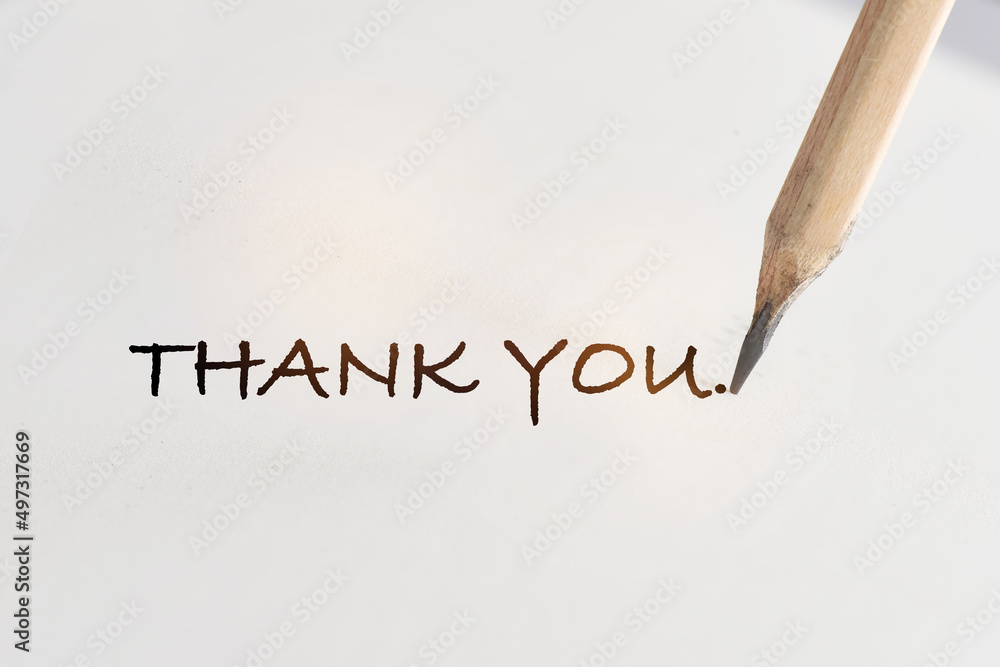 Thank you written on white paper with pencil. Communication with ...