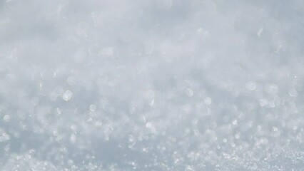 Wall Mural - Ice crystals and snowflakes shine and sparkle. Surface is covered with snow. Pan.