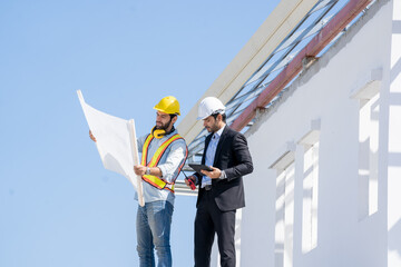 Fototapete - Engineer with business manager are talking in construction site,Project owner with blueprint working to new residential home building work site.