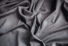 Gray Wrinkled Draped Fabric. Sewing Material Is On The Table.