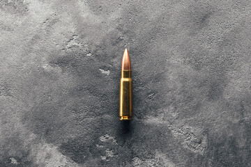 Bullet on gray background. Cartridge 7.62 caliber for Kalashnikov assault rifle