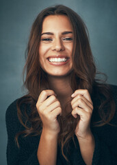 Wall Mural - Be your own kind of beautiful. Portrait of a beautiful young woman smiling against a gray background in studio.