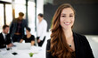 © Alexandra/peopleimages.com - My team will get it done. Portrait of a businesswoman standing in a boardroom meeting with colleagues in the background.