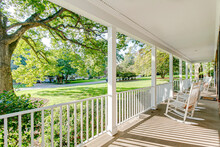 Southern Country Living Covered Front Porch Summer Spring Day Tree Sunlight Warm Sunshine White Rocking Chairs