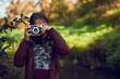 © Ruan J/peopleimages.com - Its like seeing the world through new eyes. Shot of a young girl taking pictures with a vintage camera outdoors.