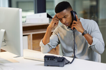 Aufkleber - Delivering bad news is a tough call to make. Shot of a young man using a phone and looking stressed in a modern office.