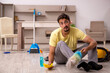 © Elnur - Young man doing housework at home