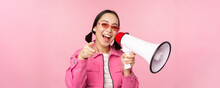 Attention, Announcement Concept. Enthusiastic Asian Girl Shouting In Megaphone, Advertising With Speaker, Recruiting, Standing Over Pink Background