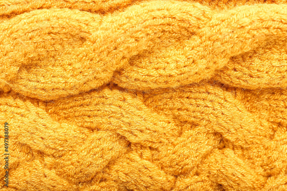 Texture of yellow knitted clothes, closeup