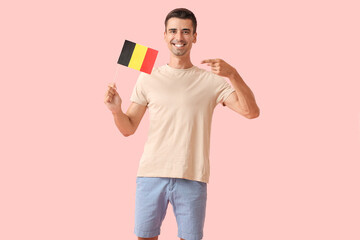 Poster - Young man with flag of Belgium on color background