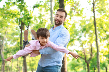 Poster - Little boy having fun with his father in park