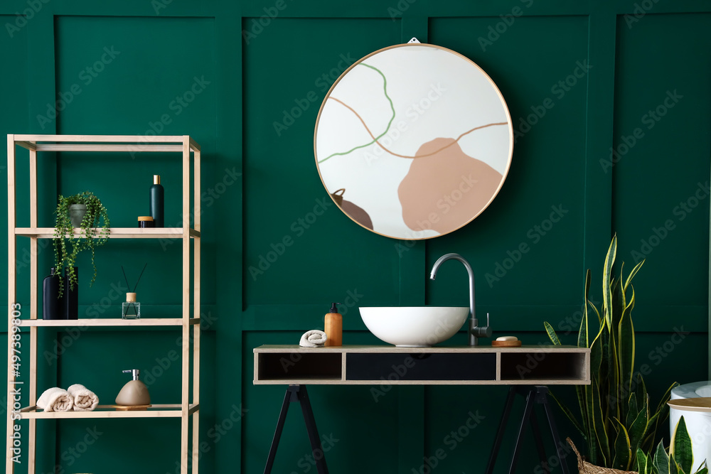 Interior of stylish bathroom with sink, mirror and shelving unit