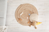Fototapeta  - Wicker carpet with pouf and toys in children's room