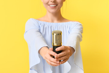 Sticker - Young woman with professional microphone on yellow background, closeup