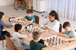 © Pixel-Shot - Little children playing chess during tournament in club