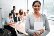 © Micah C/peopleimages.com - This is where we come up with all our winning ideas. Cropped portrait of an attractive young businesswoman attending a meeting in the boardroom with her colleagues in the background.