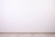 © New Africa - Empty room with white wall and wooden floor