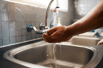 Canvas Print - Do you keep your hands clean. Cropped shot of an unrecognizable man washing his hands in the kitchen sink at home.