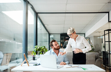 Wall Mural - id like you to change that please. shot of two businesspeople working together on a laptop in an off