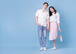 © Timeimage - Full length image of young Asian couple on blue background