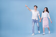 © Timeimage - Full length image of young Asian couple on blue background