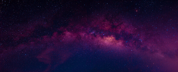 Wall Mural - Milky way in the night sky and stars on dark background with noise and grain. Photo taken with long exposure and white balance selected.