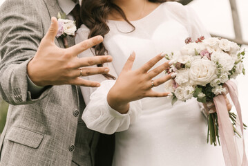 The bride and groom exchange wedding rings, close-up