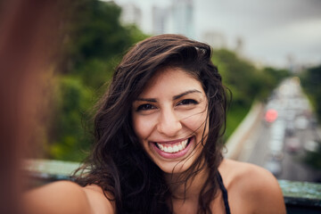 Ready for some adventures around town. Portrait of an attractive young woman taking a selfie out in the city.