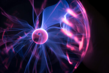 hands holding plasma light ball on black background