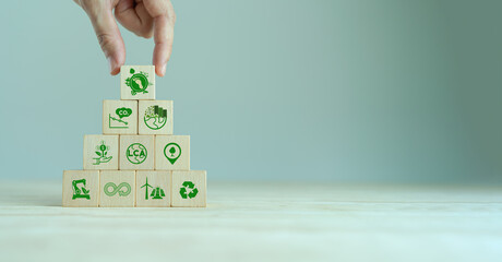 Carbon footprint, low carbon emission concept. Carbon ecological footprint symbols on wooden cube with eco friendly icon. Sustainable business development.Environmental, climate change concept. LCA.