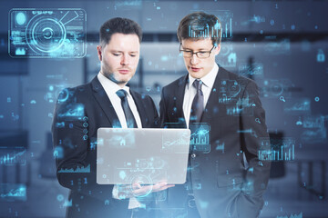 Wall Mural - Attractive european businessmen using laptop with abstract creative business charts and binary code on blurry office interior background. System engineering and digital transformation concept. 