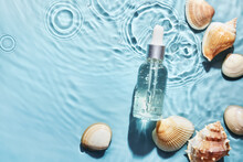 Organic Cosmetic With With Sea Minerals. Skincare Cosmetic Product And Shells On Blue Water Background